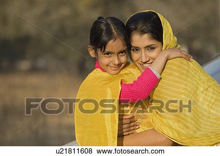 Stock Photo - Rural mother hugging her daughter. Fotosearch