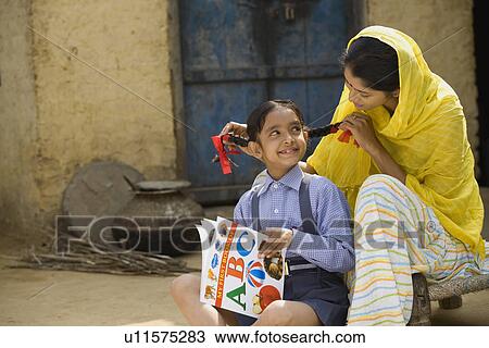Stock Image - Rural mother playing with her daughter. Fotosearch