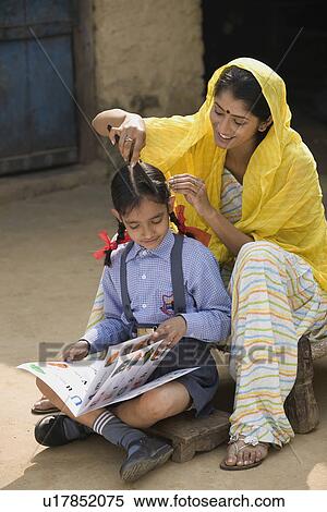 Rural mother straightens her daughters h View Large Photo Image Stock Photography - Rural mother straightens her daughters h. Fotosearch