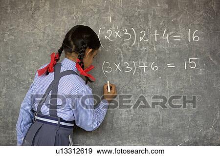 Rural school girl writing on the board View Large Photo Image Stock Photo - Rural school girl writing on the board. Fotosearch