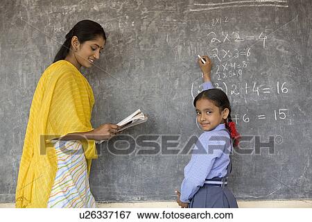 Rural student writes on the board as tea View Large Photo Image Stock Photo - Rural student writes on the board as tea. Fotosearch
