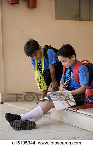 Picture - School boy sitting on the steps. Fotosearch