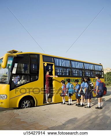 School children getting onto a school bus View Large Photo Image Picture - School children getting onto a school bus. Fotosearch