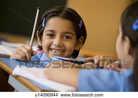 School girl at her desk View Large Photo Image Picture - School girl at her desk. Fotosearch