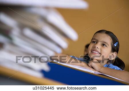 Stock Photography - School girl at her desk. Fotosearch