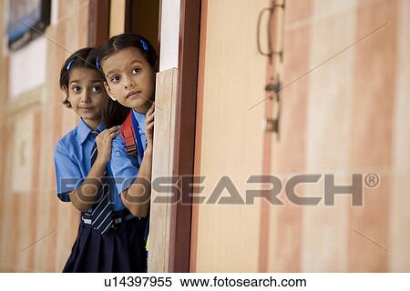 School girls peeping from a classroom View Large Photo Image Stock Photography - School girls peeping from a classroom. Fotosearch