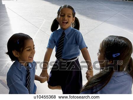 Stock Photo - School girls playing. Fotosearch