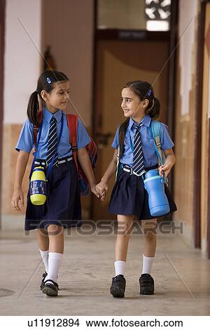 Picture - School girls walking together. Fotosearch