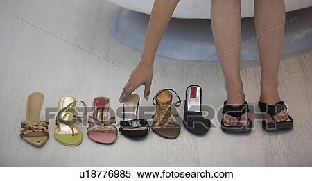 Stock Photography - Selecting shoes. Fotosearch