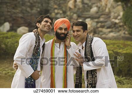 Stock Image - Sikh man talks on his phone. Fotosearch