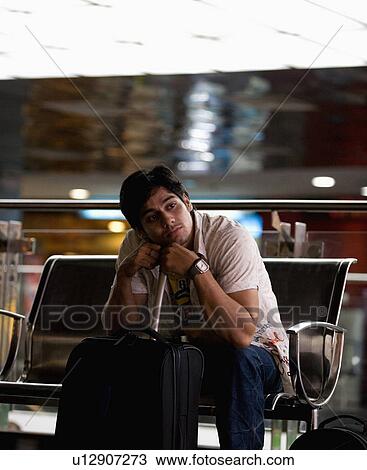 Stock Image - Sitting with luggage. Fotosearch