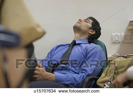 Picture - Sleeping in the office. Fotosearch