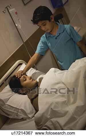 Son feeling his mother's forehead View Large Photo Image Stock Photo - Son feeling his mother's forehead. Fotosearch