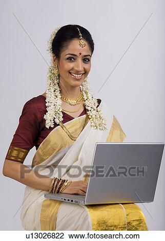 South Indian woman with a laptop View Large Photo Image Stock Image - South Indian woman with a laptop. Fotosearch