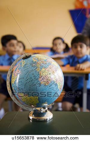 Students looking at a globe View Large Photo Image Stock Photo - Students looking at a globe. Fotosearch