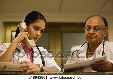 Stock Image - Two doctors consulting. Fotosearch