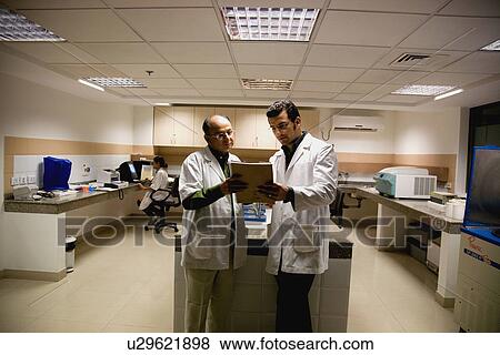 Two doctors consulting View Large Photo Image Stock Photo - Two doctors consulting. Fotosearch