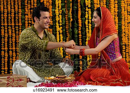 Tying a rakhi View Large Photo Image Stock Image - Tying a rakhi. Fotosearch