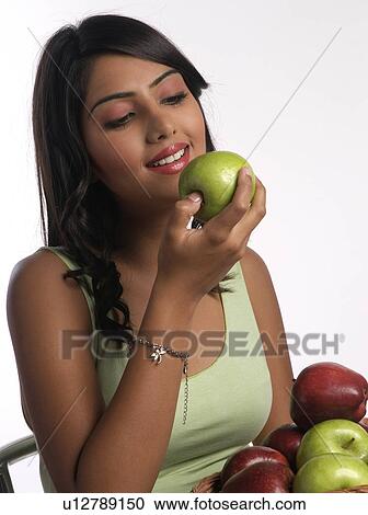 Stock Image - Woman about to eat an Apple. Fotosearch