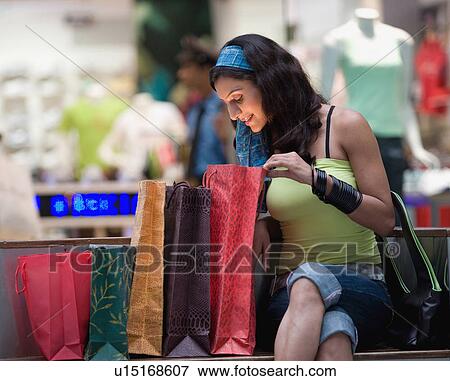 Stock Photo - Woman admiring her shopping. Fotosearch