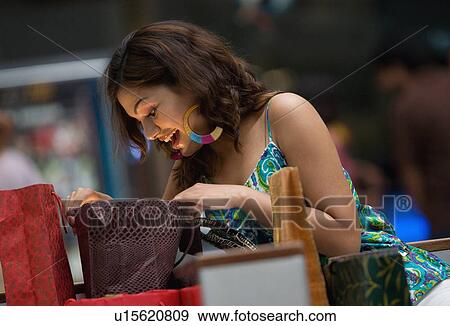 Woman admiring her shopping View Large Photo Image Stock Photo - Woman admiring her shopping. Fotosearch