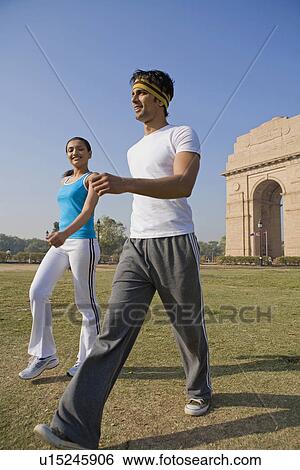 Stock Photograph - Woman and man exercising. Fotosearch
