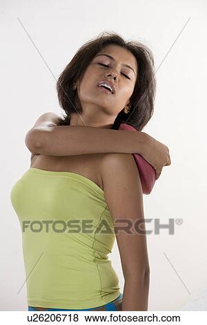 Stock Photo - Woman applying a hot water bag. Fotosearch