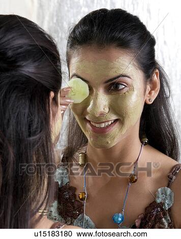 Stock Image - Woman applying face mask. Fotosearch