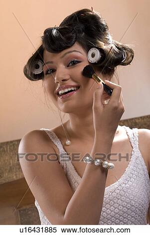 Stock Photography - Woman applying make-up. Fotosearch