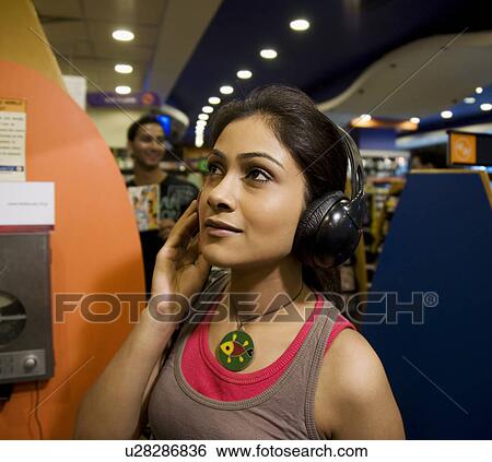Woman at a music store View Large Photo Image Stock Photograph - Woman at a music store. Fotosearch