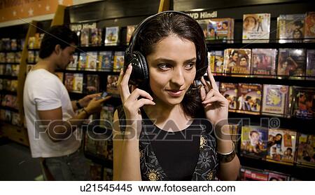 Stock Photography - Woman at a music store. Fotosearch