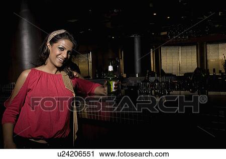 Stock Image - Woman at the bar counter. Fotosearch