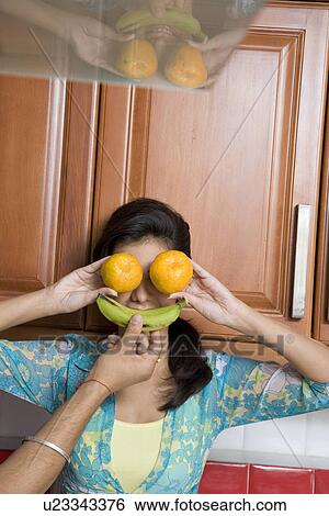 Woman covering her face with fruits View Large Photo Image Stock Photograph - Woman covering her face with fruits. Fotosearch