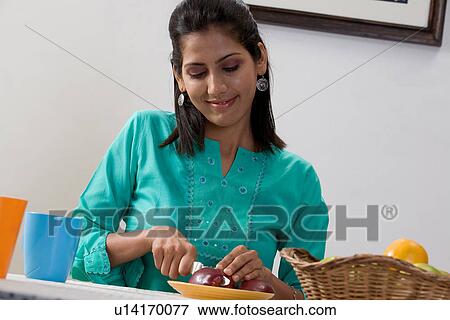 Woman cutting fruit View Large Photo Image Stock Photo - Woman cutting fruit. Fotosearch