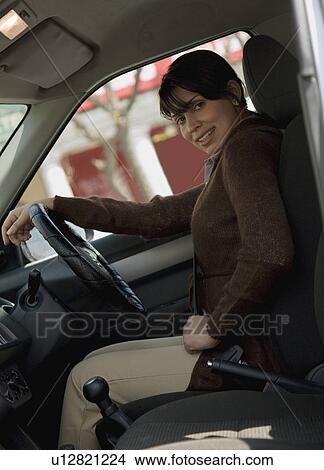 Woman driving a car View Large Photo Image Picture - Woman driving a car. Fotosearch