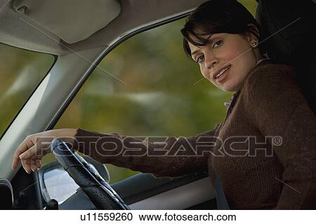 Woman driving a car View Large Photo Image Stock Image - Woman driving a car. Fotosearch