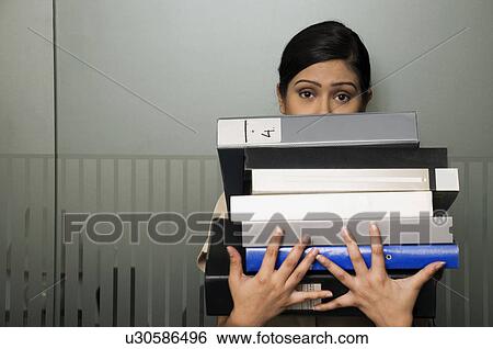 Woman executive holding some files View Large Photo Image Stock Photograph - Woman executive holding some files. Fotosearch