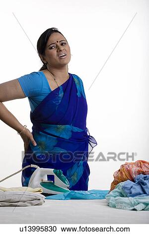Stock Image - Woman getting a backache. Fotosearch