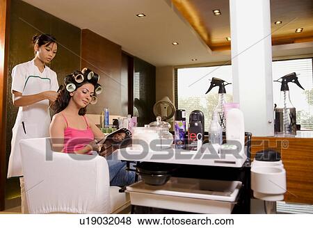 Woman getting her hair styled View Large Photo Image Stock Photo - Woman getting her hair styled. Fotosearch