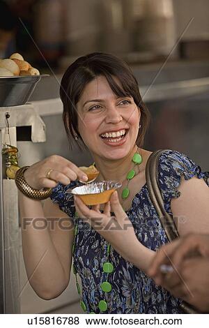 Stock Photo - Woman having Gol Gappas. Fotosearch