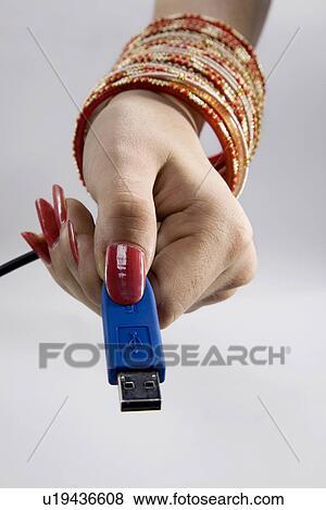 Woman holding pen drive View Large Photo Image Stock Photo - Woman holding pen drive. Fotosearch