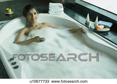 Stock Image - Woman in bathtub. Fotosearch