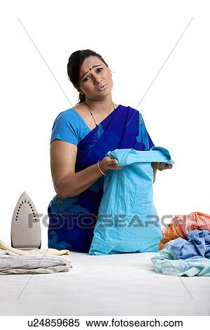 Stock Photography - Woman ironing clothes. Fotosearch