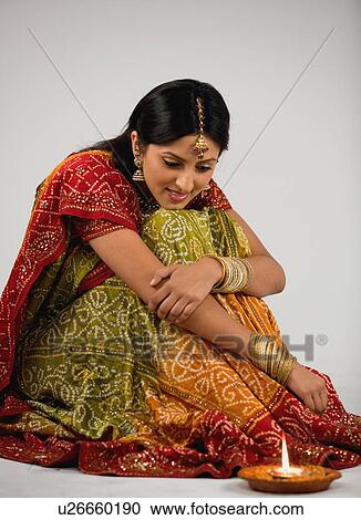Woman looking at diya View Large Photo Image Stock Image - Woman looking at diya. Fotosearch