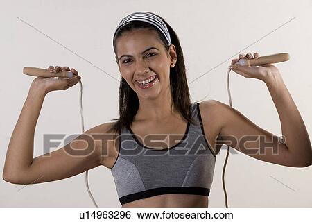 Stock Photograph - Woman posing with skipping rope. Fotosearch