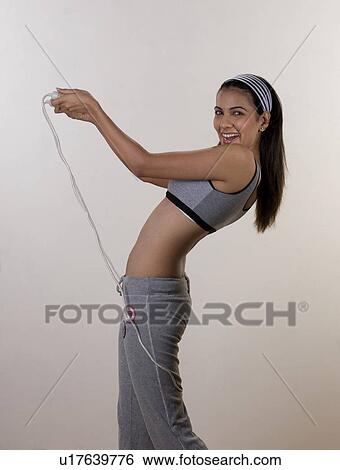 Stock Photograph - Woman posing with skipping rope. Fotosearch