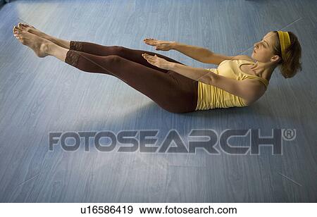 Stock Photo - Woman practicing yoga. Fotosearch