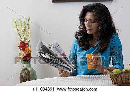 Woman reading newspaper View Large Photo Image Stock Image - Woman reading newspaper. Fotosearch