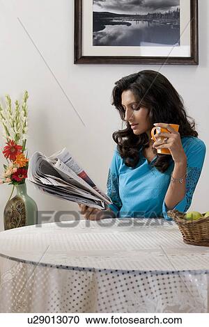 Woman reading newspaper View Large Photo Image Stock Image - Woman reading newspaper. Fotosearch