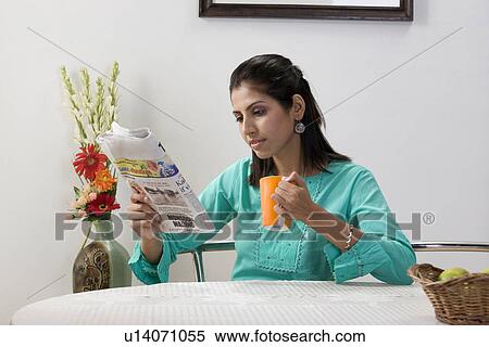 Woman reading newspaper View Large Photo Image Stock Photography - Woman reading newspaper. Fotosearch